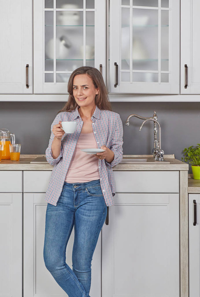 Cheerful woman enjoying a coffee - Фото, изображение