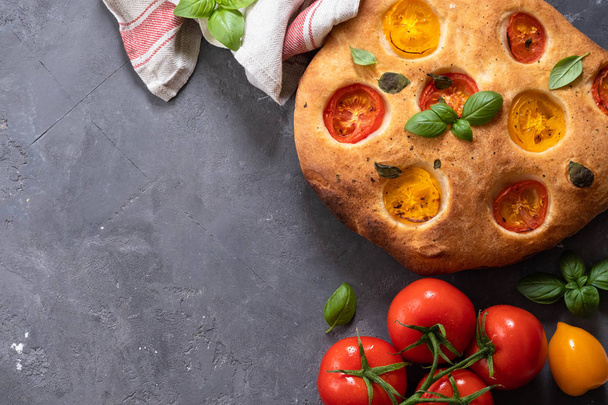 Focaccia with tomatoes and basil. Italian bread. Top view. Copy space. - Foto, immagini