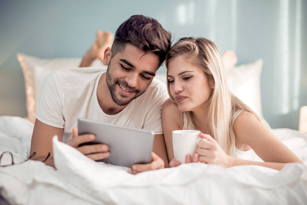 Tablet pc を自宅でビデオを見て幸せなカップル  - 写真・画像