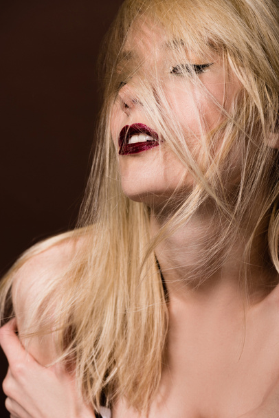seductive naked blonde woman posing on brown - Fotó, kép