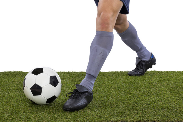detail of football player feet kicking a ball on the grass on white background - Foto, imagen