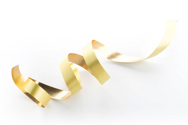 Golden ribbon roll isolated on white background - 写真・画像