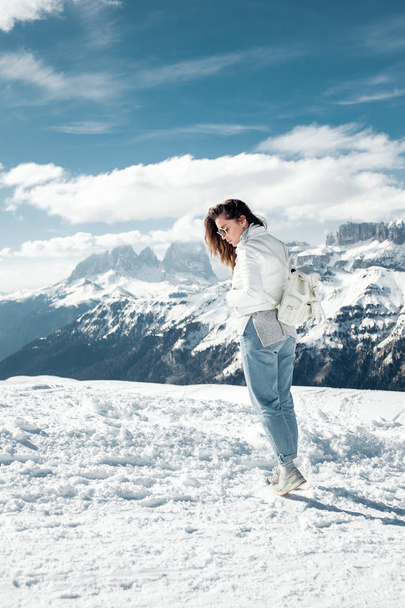 Girl in the snowy mountains. Holiday in the ski resort of northern Italy.  Tour to the Dolomites. - Φωτογραφία, εικόνα