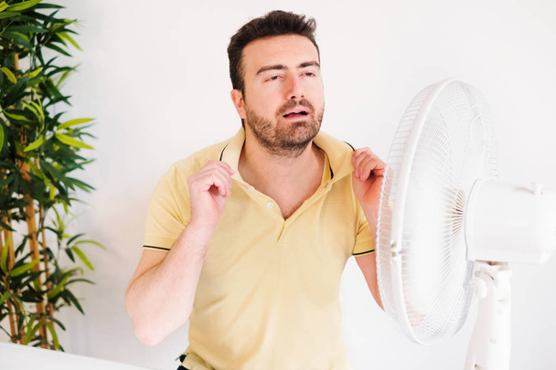 Young man sweating because summer heat haze - Valokuva, kuva