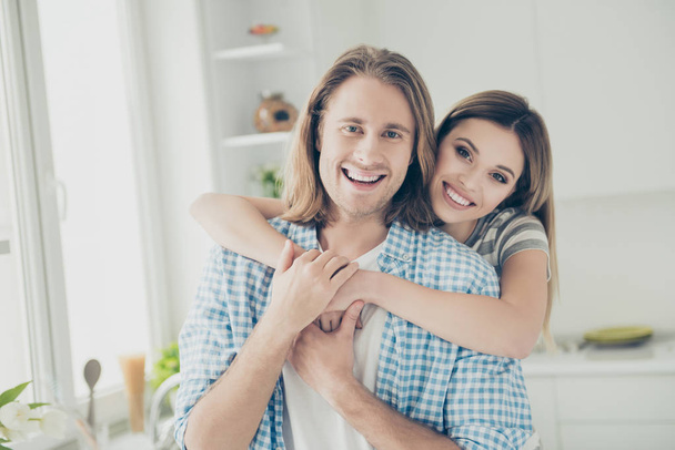 Portrait of romantic attractive couple hugging looking at camera enjoying time at home together looking at camera. Trust support understanding concept - Fotografie, Obrázek