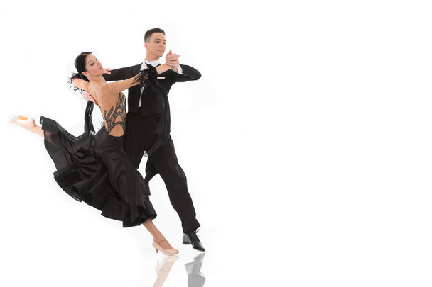 ballroom dance couple in a dance pose isolated on white background. ballroom sensual proffessional dancers dancing walz, tango, slowfox and quickstep ballroom couple dance professional - Foto, imagen