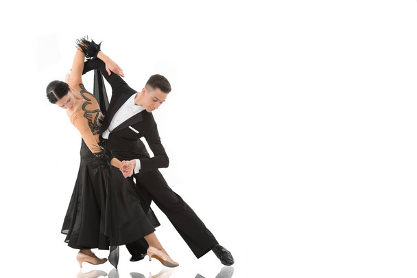 ballroom dance couple in a dance pose isolated on white background. ballroom sensual proffessional dancers dancing walz, tango - Photo, Image
