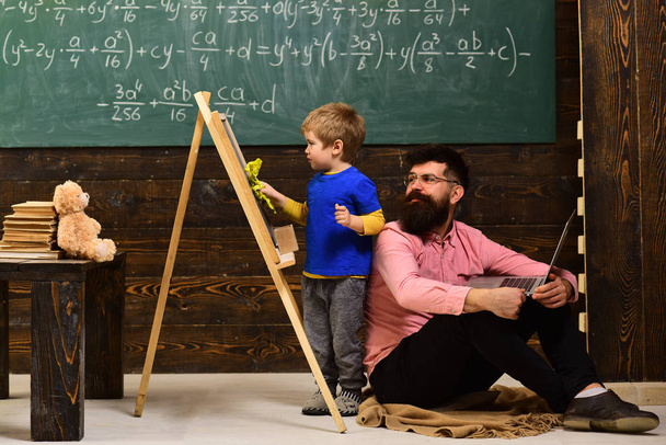 Lesson with qualified private tutor. Teacher starts the lesson. Portrait of diligent schoolkid and teacher talking at lesson. Worry student have a problem with mathematics. - Photo, image