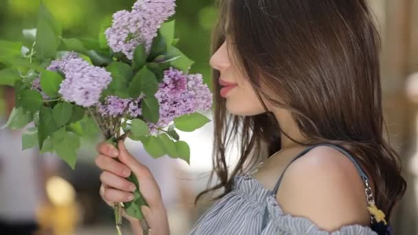 Happy woman enjoying fresh lilac smell - Footage, Video