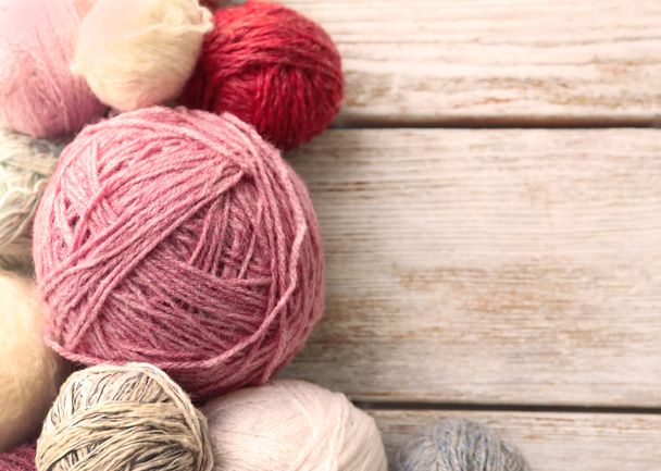 Balls of knitting yarn on wooden background - Valokuva, kuva