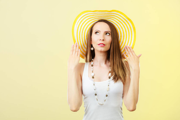 Holidays summer fashion and head protection. Woman in big yellow hat. Portrait of charming female on bright background. - Photo, Image