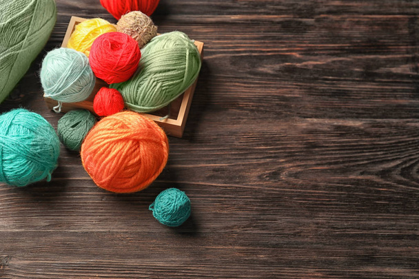 Box with color knitting threads on wooden background - Valokuva, kuva
