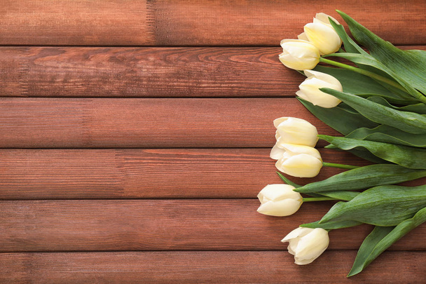 Beautiful tulips on wooden background - Foto, Imagen