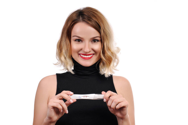 Pregnant. Happy woman showing a positive pregnancy test - Photo, image