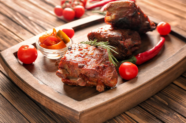 Delicious grilled ribs with vegetables on wooden board - Φωτογραφία, εικόνα