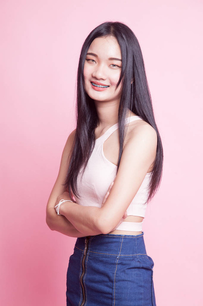 Portrait of beautiful young Asian woman on pink background - Фото, зображення