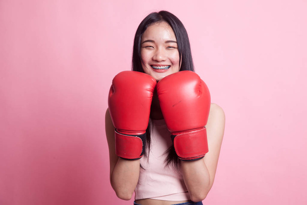 Young Asian woman with red boxing gloves on pink background - Φωτογραφία, εικόνα