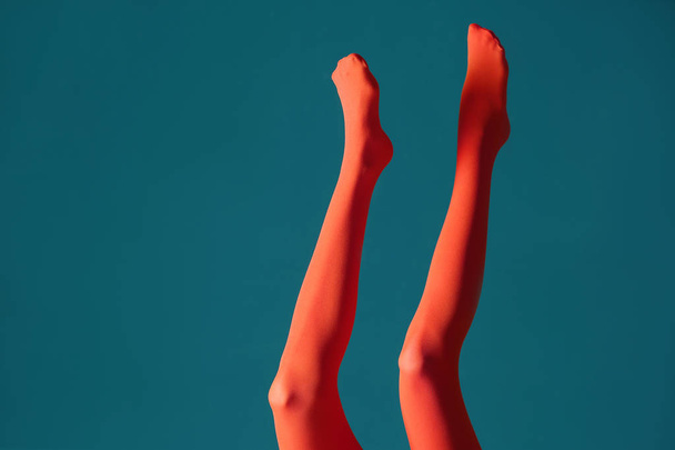 Legs of beautiful young woman in tights on color background - Фото, изображение