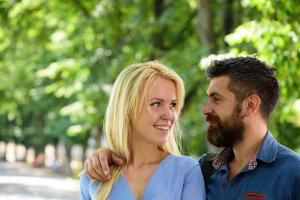 Man hugs happy blonde girlfriend, put hand on her shoulder. - Foto, Imagen