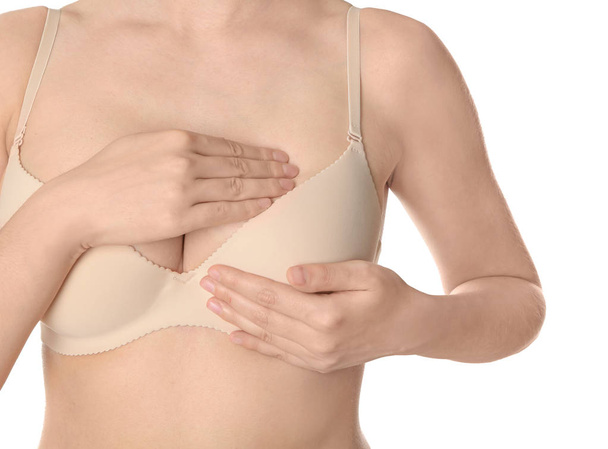 Woman examining her breast on white background, closeup. Cancer awareness concept - Zdjęcie, obraz