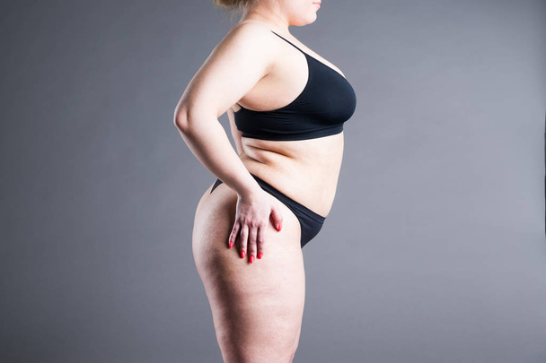 Overweight woman with fat belly, obesity female body on gray background - 写真・画像