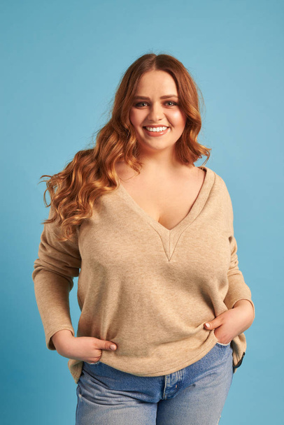 Casual plump woman with hands in pocket posing at the camera  - Photo, Image