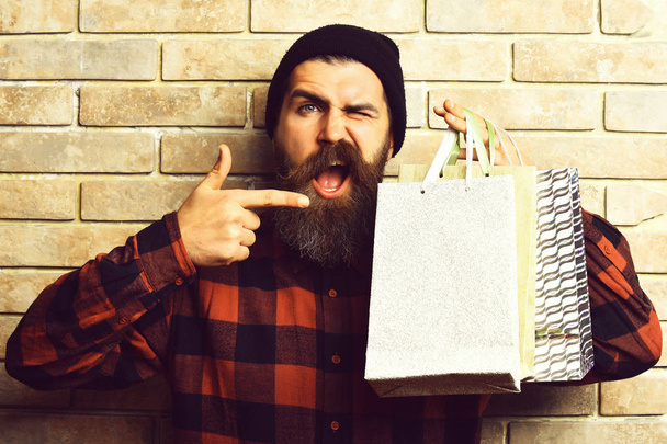 Bearded brutal caucasian hipster with moustache holding shopping packages - Fotoğraf, Görsel