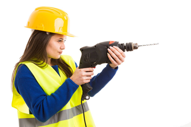Young female engineer or architect using drilling machine as electric building tool concept isolated on white background - Foto, Bild