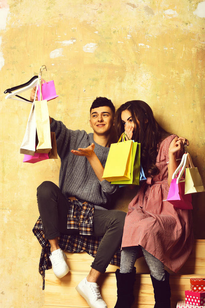 happy couple of pretty girl and young guy with packages - Foto, Imagem