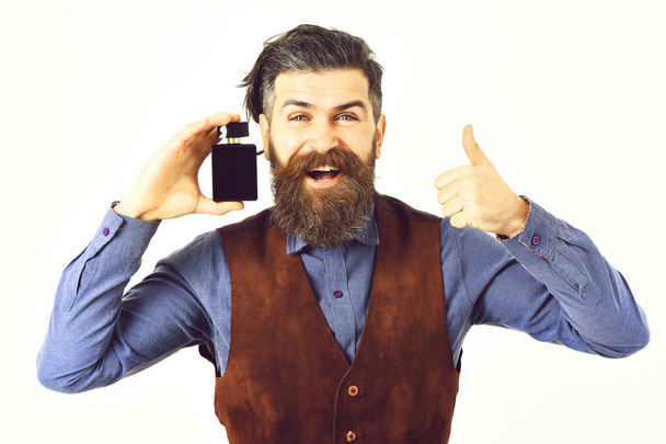 bearded man holding perfume with happy face - Foto, Imagem