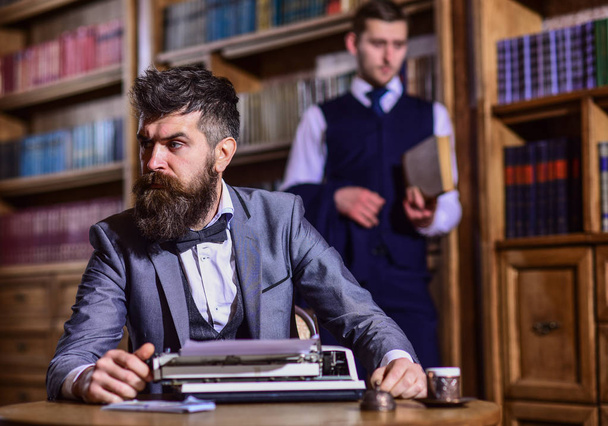 Man with beard and strict face work with typewriter - Valokuva, kuva