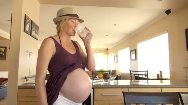 Pregnant Woman Shows Bare Belly, Drinks Water: CA, Los Angeles, United States of America - Кадри, відео