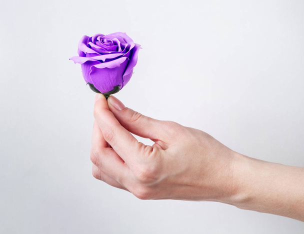Artificial flower handmade: Rose bud in hand. - Photo, image