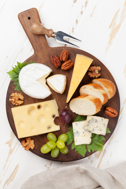 Cheese plate with grapes and nuts. Wine snacks. Top view - Photo, Image