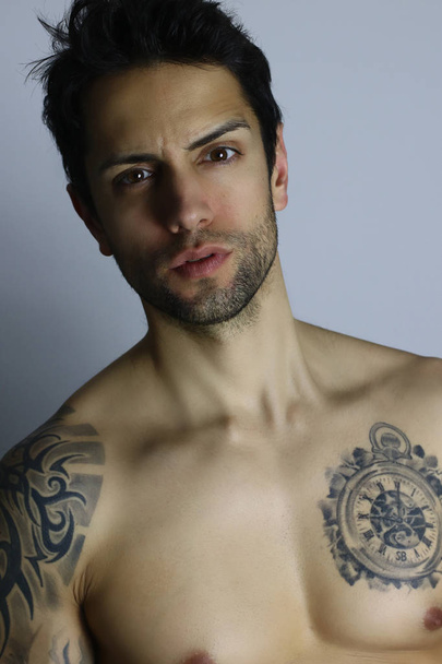 Very handsome man with tattoos, isolated on gray - Φωτογραφία, εικόνα