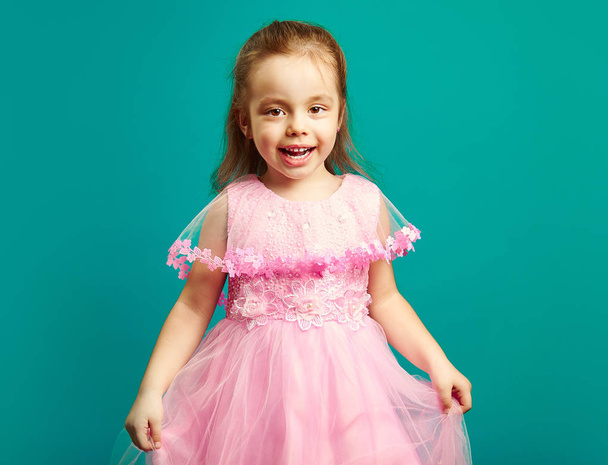 Beautiful little girl in pink dress on blue background. - Fotoğraf, Görsel