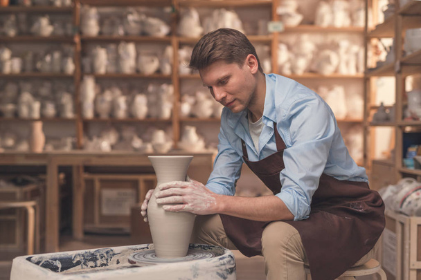 Young master in uniform in pottery - Photo, Image