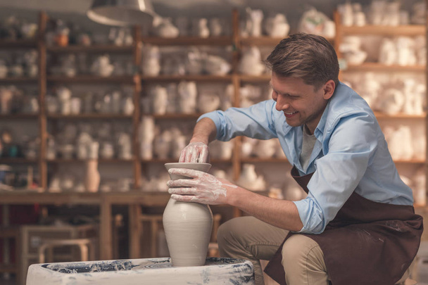 Smiling young master in uniform in pottery - Photo, Image