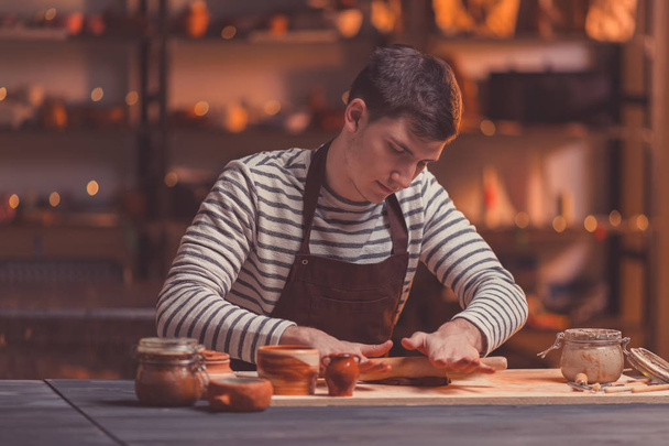 Young man at work in a pottery studio - Φωτογραφία, εικόνα