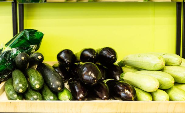 Close up of zucchini and eggplants at showcase in supermarket - 写真・画像