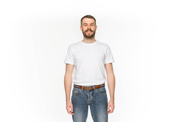 Closeup of young mans body in empty white t-shirt isolated on white background. Mock up for disign concept - Fotó, kép