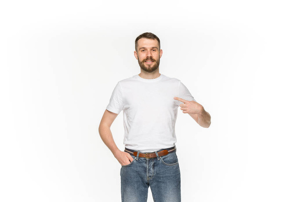 Closeup of young mans body in empty white t-shirt isolated on white background. Mock up for disign concept - 写真・画像