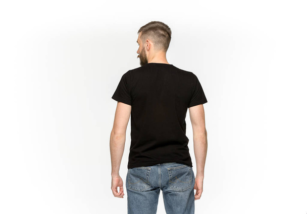 Closeup of young mans body in empty black t-shirt isolated on white background. Mock up for disign concept - Foto, afbeelding