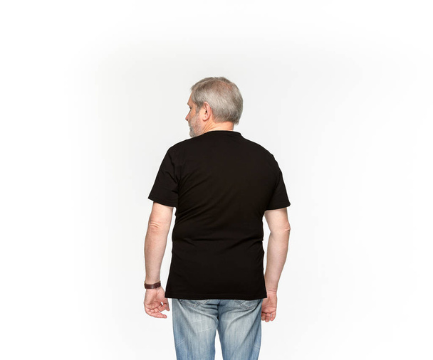 Closeup of senior mans body in empty black t-shirt isolated on white background. Mock up for disign concept - Foto, Bild