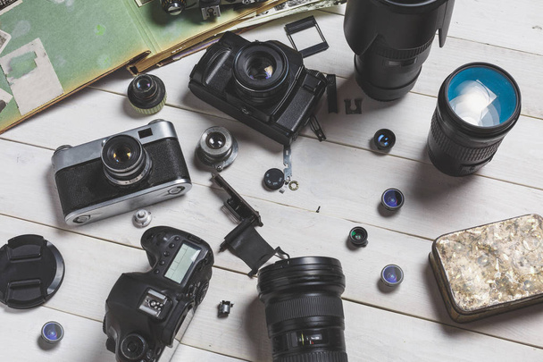 Error Repair Support Center Concept. Film camera, components, digital camera and lenses on wooden background.  technology development concept - Photo, Image