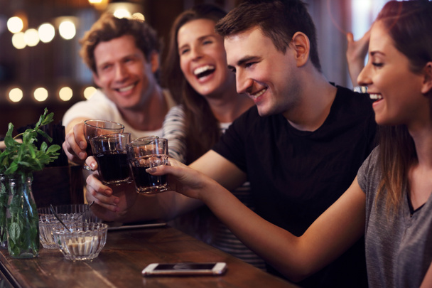Group of friends watching soccer in pub - Photo, Image