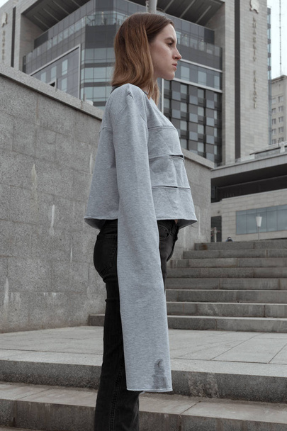 Stylish girl in conceptual designer clothes on urban background - Valokuva, kuva