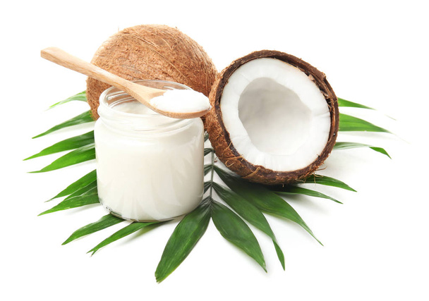 Jar with coconut oil and nuts on white background - Zdjęcie, obraz