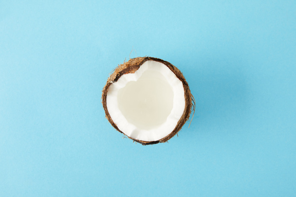 top view of fresh cut coconut isolated on blue - Fotografie, Obrázek