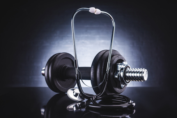 close-up view of stethoscope and dumbbell, healthy lifestyle concept   - Photo, Image